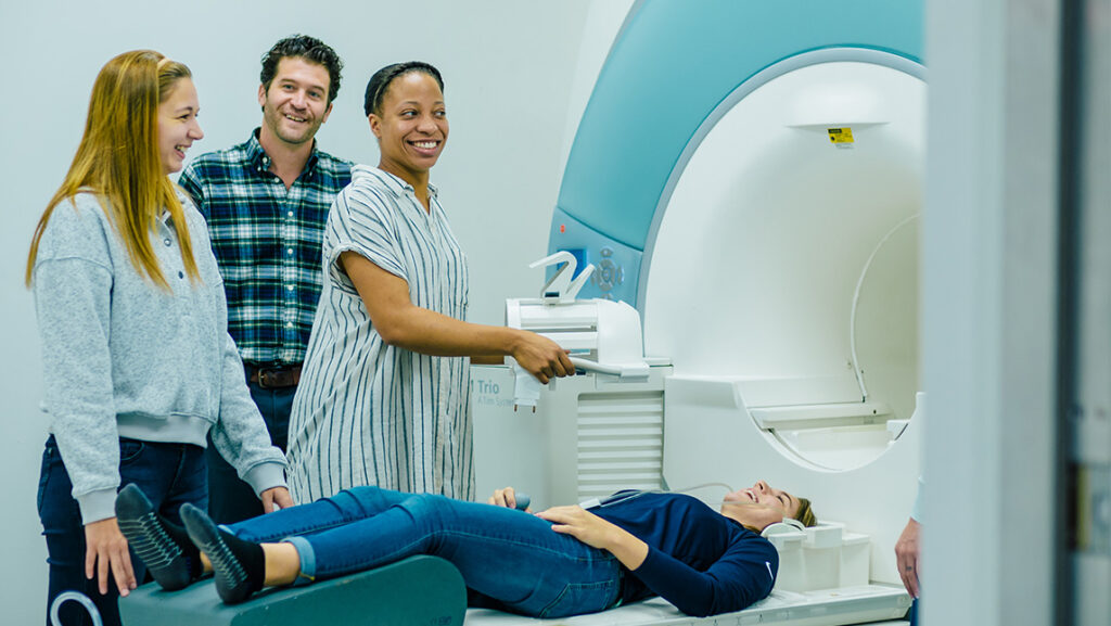 UNCG's Dr. Derek Monroe trains graduate students at the MRI Gateway Center
