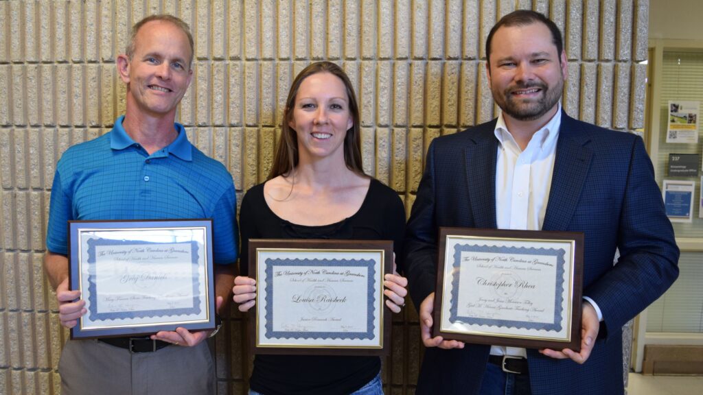 Dr. Greg Daniels, Dr. Louisa Raisbeck, and Dr. Christopher Rhea with their awards